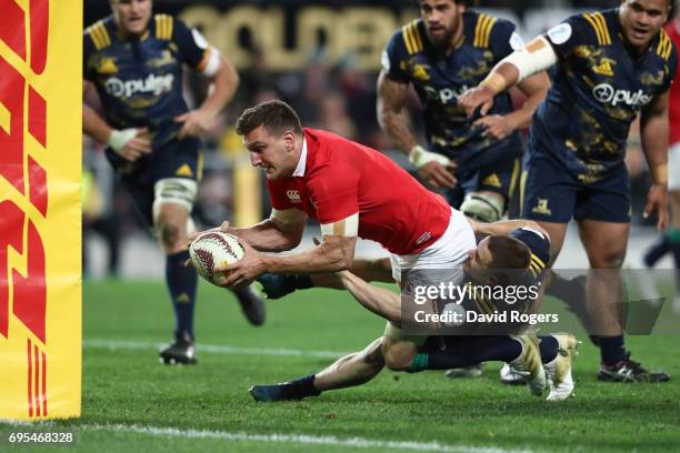 Sam Warburton of the Lions drives through the tackle from Kayne Hammington of the Highlanders to score his team's third try during the 2017 British &...