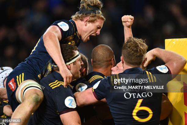 Otago Highlanders' James Lentjes celebrates with teammates after victory during the rugby union match between the Otago Highlanders and the British...