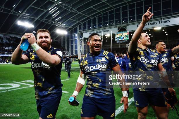 Liam Coltman, Waisake Naholo and Dan Linert-Brown of the Highlanders celebrate after winning the match between the Highlanders and the British &...