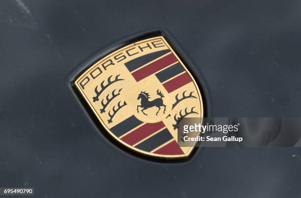 Hood ornament shows the Porsche logo on a Porsche Cayenne diesel SUV parked on June 13, 2017 in Berlin, Germany. Spiegel magazine, after conducting...