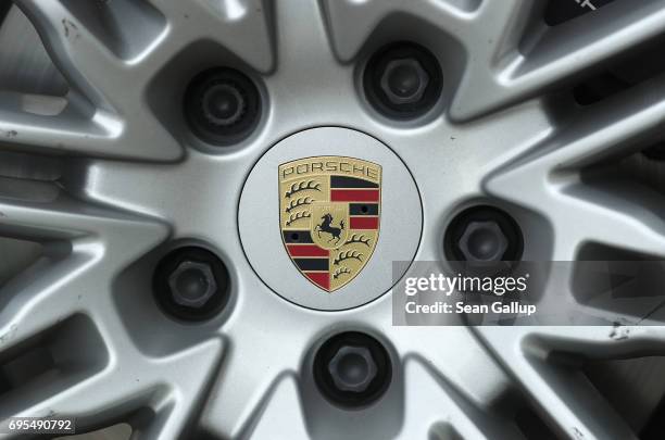 Hubcap ornament shows the Porsche logo on a Porsche Cayenne diesel SUV parked on June 13, 2017 in Berlin, Germany. Spiegel magazine, after conducting...