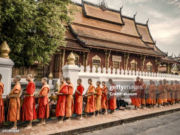 alms giving ceremony in luang prabang laos - alms stock pictures, royalty-free photos & images