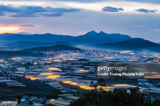 view from lang biang mountain to dalat city, vietnam. we can see the lights from the cage houses to grow shimmering vegetables. - touristical stock pictures, royalty-free photos & images
