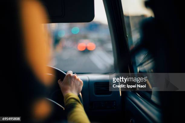 driving on urban road in city, tokyo - steering wheel stockfoto's en -beelden