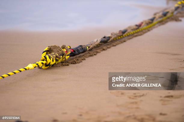 An undersea fiber optic cable is attached to a rope at Arrietara beach near the Spanish Basque village of Sopelana on June 13, 2017. Facebook and...