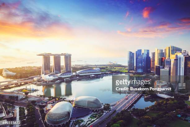 aerial view of singapore skyline business district and cityscape at twilight in singapore, asia. - perth australia foto e immagini stock