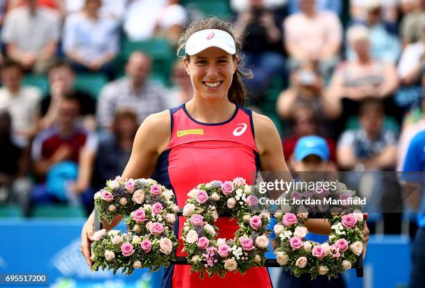 Johanna Konta of Great Britain is presented with a wreath to commemorate her 300th singles career win after her victory over Tara Moore of Great...
