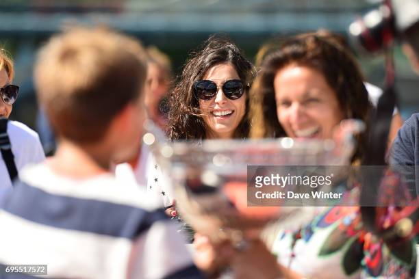 Girlfriend of Rafael Nadal, Xisca Perello, watches as his friends and family pose with the trophy during the photocall to celebrate his record...
