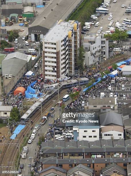 File photo taken in April 2005 shows a train derailment on the JR Fukuchiyama Line that killed 106 passengers and the driver while injuring 562 in...