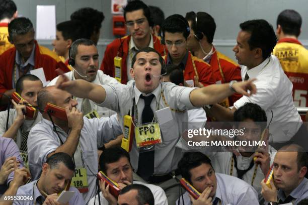 Stock traders negotiate in the future dollar pit during the morning session at the Mercantile & Futures Exchange , in Sao Paulo, Brazil, on September...