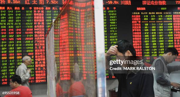 Chinese investors in front of a stock price board showing falling prices at a private security firm in Shanghai on October 6 , 2008. Chinese share...