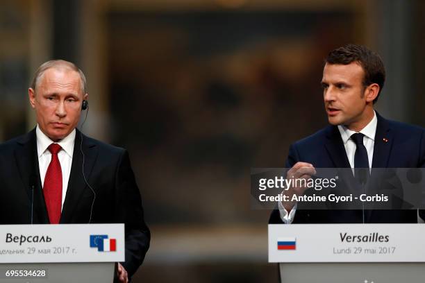 Russian President Vladimir Putin and French President Emmanuel Macron hold a joint press conference at 'Chateau de Versailles' on May 29, 2017 in...