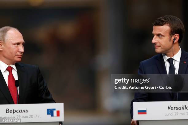 Russian President Vladimir Putin and French President Emmanuel Macron hold a joint press conference at 'Chateau de Versailles' on May 29, 2017 in...