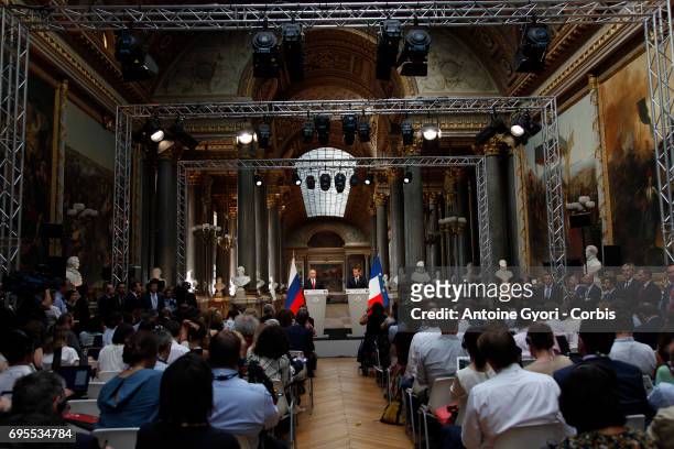 Russian President Vladimir Putin and French President Emmanuel Macron hold a joint press conference at 'Chateau de Versailles' on May 29, 2017 in...