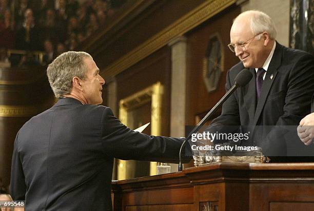 President George W. Bush shakes hands with Vice President Dick Cheney before delivering his State Of the Union address before a joint session of...