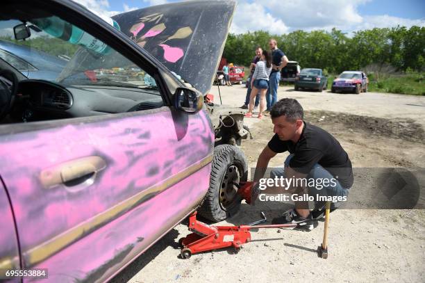 Drivers during the car service participates in the XVI Mazowiecki Wrak Race on May 27, 2017 in Mysiadlo, Poland. During the race, the participants...