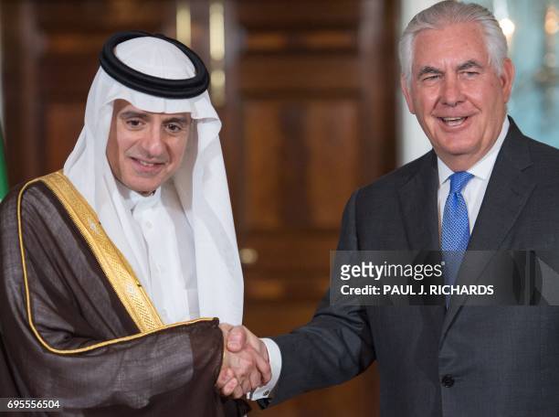 Secretary of State Rex Tillerson shake hands with Saudi Foreign Minister Adel al-Jubeir on June 13 shortly before their private meeting at the US...