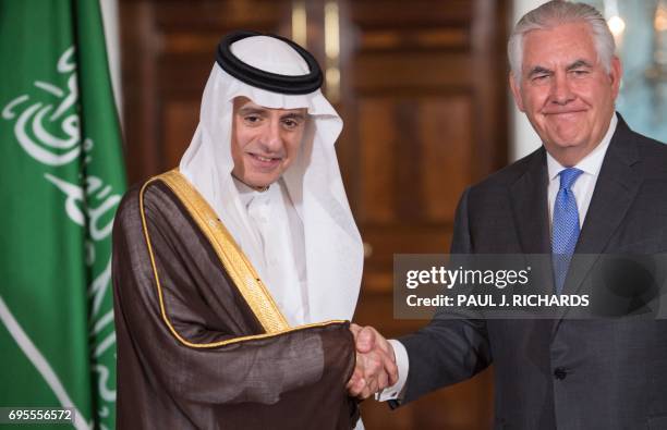 Secretary of State Rex Tillerson shake hands with Saudi Foreign Minister Adel al-Jubeir on June 13 shortly before their private meeting at the US...