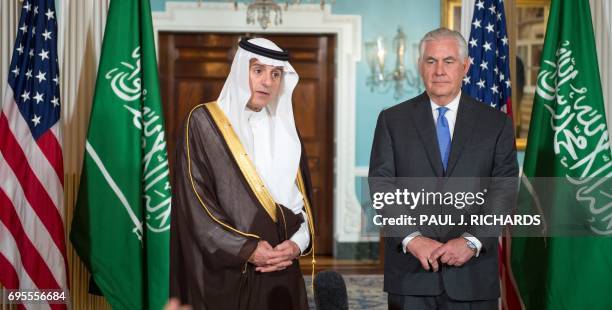 Secretary of State Rex Tillerson listens as Saudi Foreign Minister Adel al-Jubeir delivers brief remarks to the media on June 13 shortly before their...