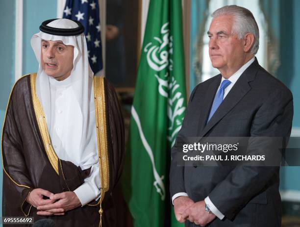 Secretary of State Rex Tillerson listens as Saudi Foreign Minister Adel al-Jubeir delivers brief remarks to the media on June 13 shortly before their...