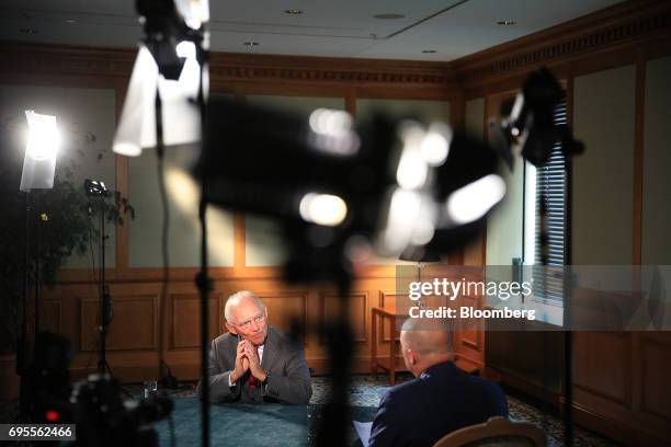 Wolfgang Schaeuble, Germany's finance minister, left, speaks during a Bloomberg Television interview at a Bloomberg G-20 event in Berlin, Germany, on...