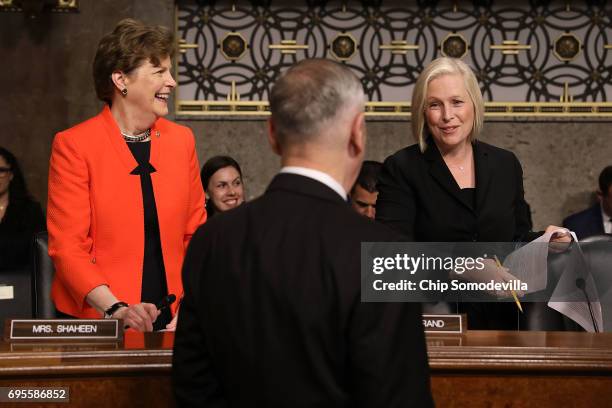 Defense Secretary James Mattis visits with Senate Armed Services Committee members Sen. Jeanne Shaheen and Sen. Kirsten Gillibrand during a hearing...
