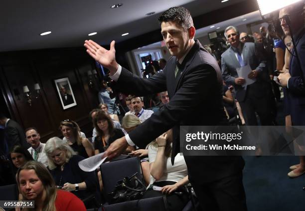 Speaker of the House Paul Ryan makes the "Cut" sign as he arrives to answer questions during a press conference June 13, 2017 in Washington, DC. Ryan...