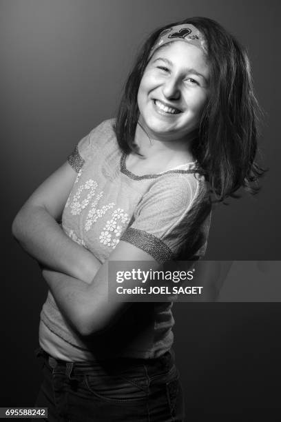 Myriam, a 13-year-old Syrian girl who wrote "Myriam's diary", a book in which she relates her day to day life during the battle of Aleppo, poses...