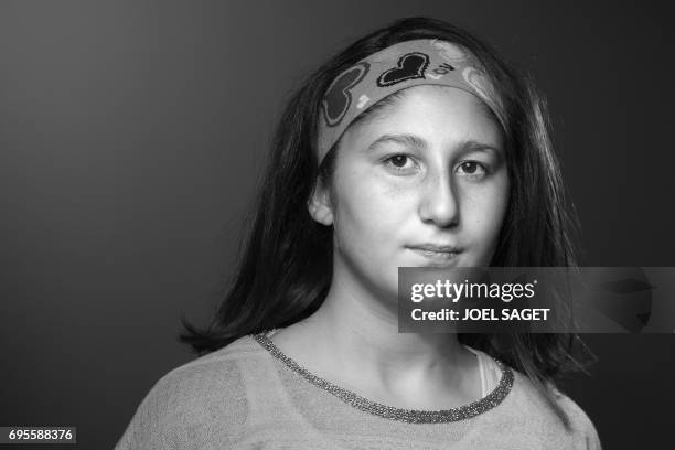 Myriam, a 13-year-old Syrian girl who wrote "Myriam's diary", a book in which she relates her day to day life during the battle of Aleppo, poses...