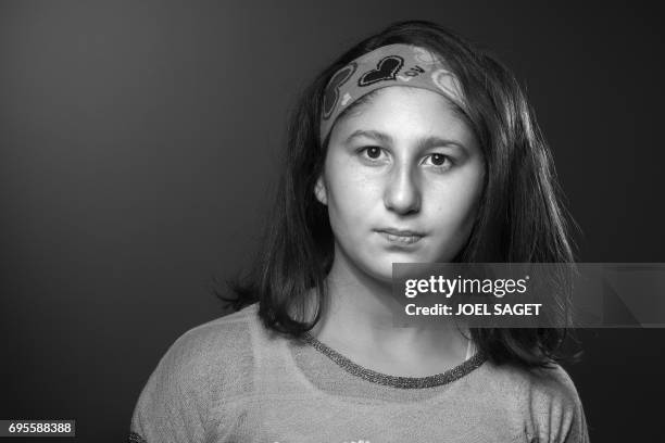 Myriam, a 13-year-old Syrian girl who wrote "Myriam's diary", a book in which she relates her day to day life during the battle of Aleppo, poses...