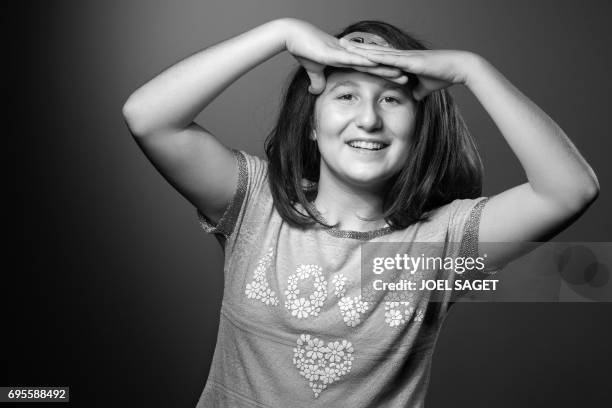 Myriam, a 13-year-old Syrian girl who wrote "Myriam's diary", a book in which she relates her day to day life during the battle of Aleppo, poses...