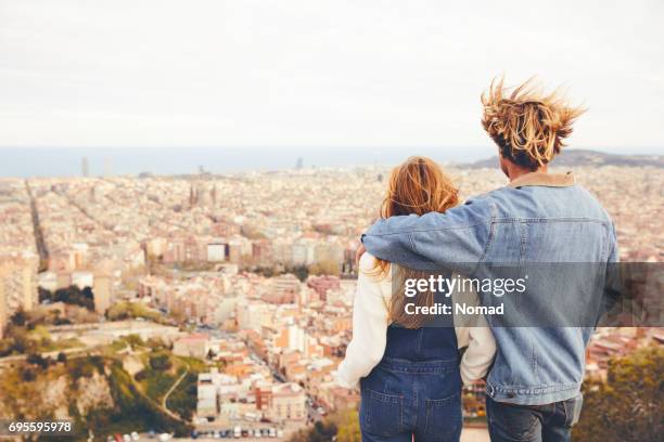 rear view of couple embracing in city - barcelona cityscape stock pictures, royalty-free photos & images