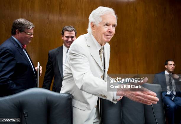 Chairman Sen. Thad Cochran, R-Miss., reaches out to shake hands with a Senate photographer before the start of the Senate Appropriations Subcommittee...