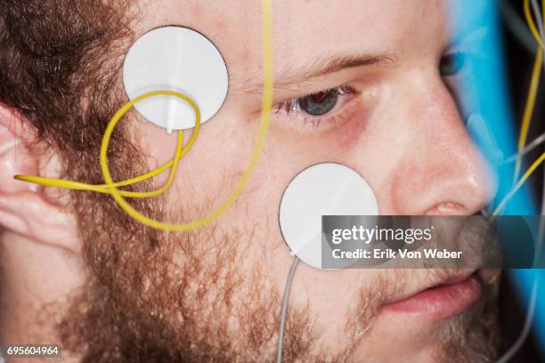 man with wires attached to his face and temples in testing scenario - electrode stock pictures, royalty-free photos & images