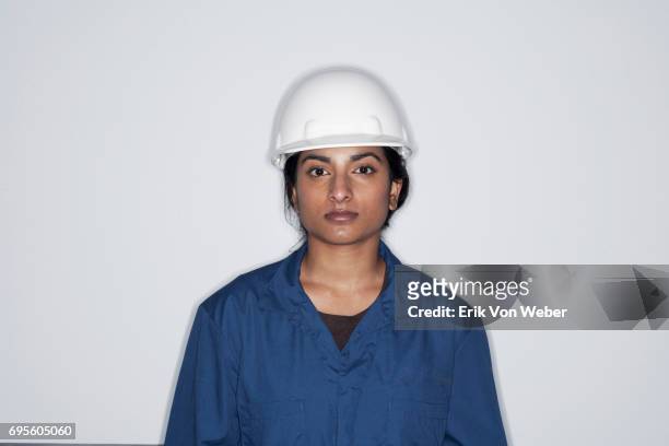 portrait woman in hard hat and jump suit - hard hat white background ストックフォトと画像