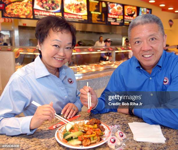 Portrait of married American restaurateurs Peggy and Andrew Cherng as they pose in one of their Panda Express drive-through locations, Irvine,...