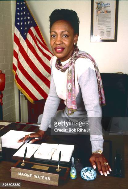 Portrait of American politician and member of the California State Assembly Maxine Waters as she sits on a desk in her office, Los Angeles,...