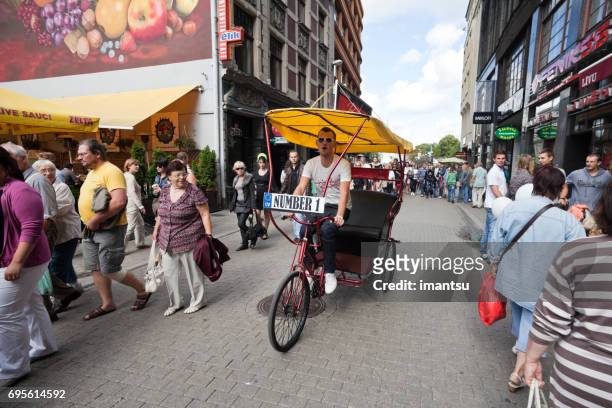 cycle rickshaw in the old town - livu square stock pictures, royalty-free photos & images