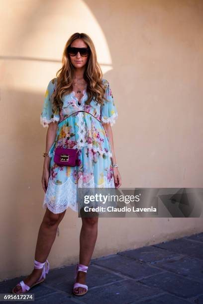 Elisa Taviti wears a Blumarine dress and a Furla bag during Pitti Immagine Uomo 92. At Fortezza Da Basso on June 13, 2017 in Florence, Italy.