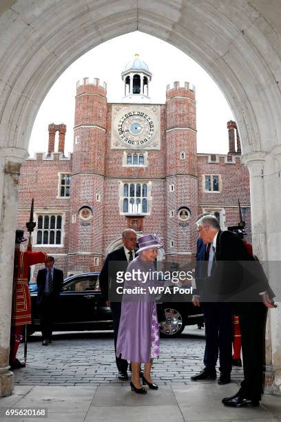 Queen Elizabeth II is greeted as she arrives to attend Evensong in celebration of the centenary of the Order of the Companions of Honour at Hampton...