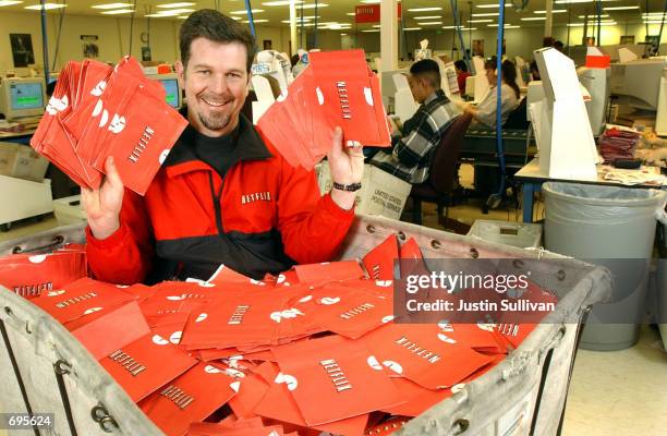 Netflix.com Chief Executive Officer Reed Hastings sits in a cart full of ready-to-be-shipped DVDs January 29, 2002 in San Jose, CA. The online DVD...