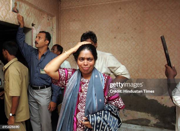 Santana de cruz cries as bmc workers come to evacuate her family from their sion koliwada residence on saturday after the bmc declared their building...