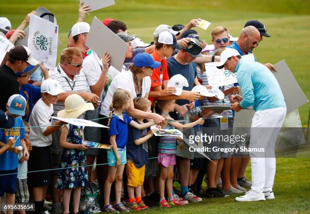 Rory McIlroy of Northern Ireland signs autographs during a practice round prior to the 2017 U.S. Open at Erin Hills on June 13, 2017 in Hartford,...