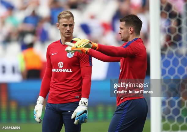 Joe Hart of England talks with Tom Heaton prior to the International Friendly match between France and England at Stade de France on June 13, 2017 in...