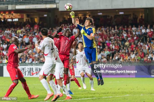 Goalkeeper Ri Myong Guk of Korea DPR reaches for the ball after an attempt at goal by Hong Kong during the 2019 Asian Cup Qualifier match between...