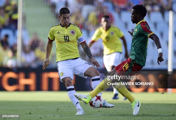 Cameroon's miedfielder Georges Mandjeck vies with Colombia's midfielder James Rodriguez during the friendly football match Cameroon vs Colombia at...