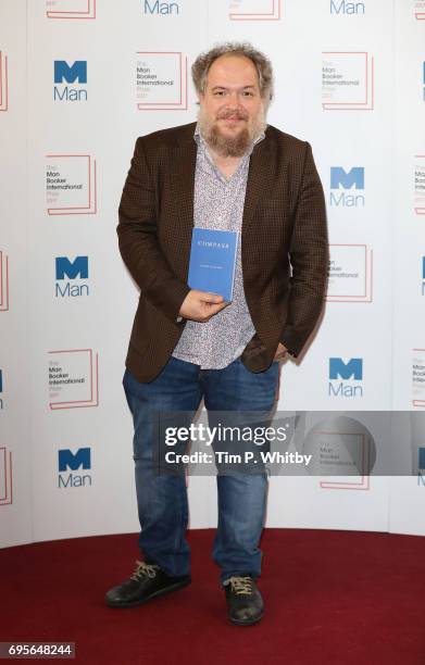 Author Mathias Enard of France with the book 'Compass' at a photocall for the shortlisted authors/translator for the Man Booker International Prize...