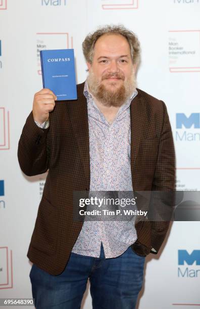 Author Mathias Enard of France with the book 'Compass' at a photocall for the shortlisted authors/translator for the Man Booker International Prize...