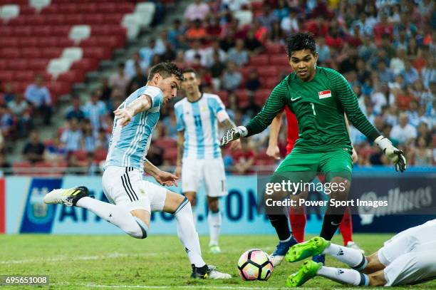 Lucas Alario of Argentina attempts a kick while being defended by Izwan Mahbud of Singapore during the International Test match between Argentina and...