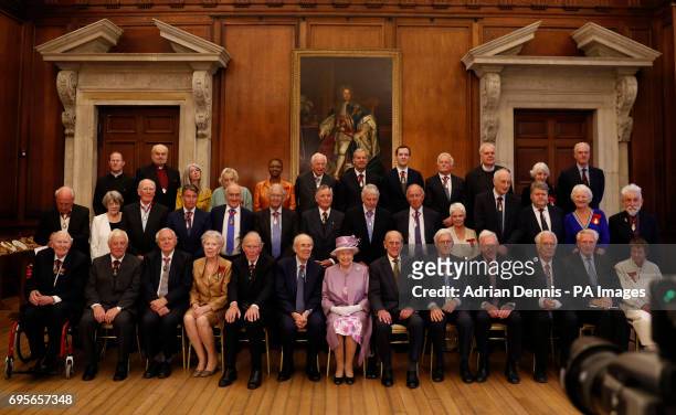 Queen Elizabeth II and the Duke of Edinburgh during a photo with Companions of Honour after a reception in celebration of the centenary of the Order...